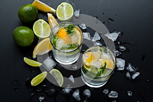 Refreshing summer  cocktail  with crushed  and citrus fruits on the dark background