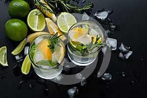 Refreshing summer  cocktail  with crushed  and citrus fruits on the dark background