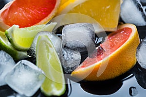 Refreshing summer  cocktail  with crushed  and citrus fruits on the dark background