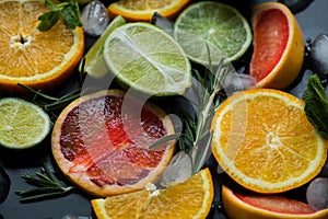 Refreshing summer  cocktail  with crushed  and citrus fruits on the dark background
