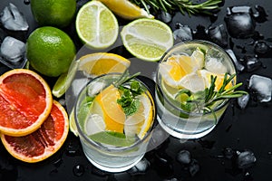 Refreshing summer  cocktail  with crushed  and citrus fruits on the dark background