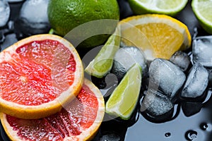 Refreshing summer  cocktail  with crushed  and citrus fruits on the dark background