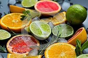 Refreshing summer  cocktail  with crushed  and citrus fruits on the dark background