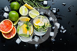 Refreshing summer  cocktail  with crushed  and citrus fruits on the dark background