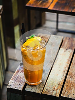 Refreshing summer drink. Peach juice or tea with peach slice, ice cube, straws and mint. Fresh Peach iced tea. Iced tea with peach