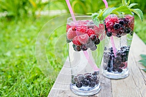 Refreshing summer drink with sparkling water and fresh berries