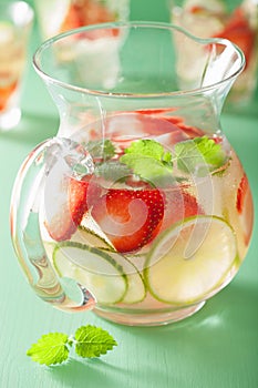 Refreshing summer drink with strawberry cucumber lime in jar and