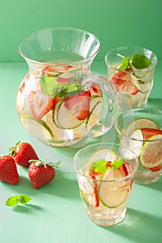 Refreshing summer drink with strawberry cucumber lime in jar and