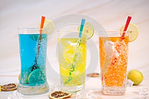 Refreshing summer drinks with alcohol on table backgroun