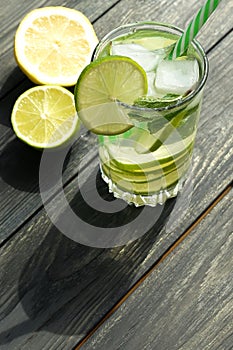 Refreshing summer drinks detox water with fresh lime and mint  on grey