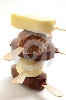 Refreshing summer food, icy cold dessert and frozen snack concept with close up on stack of sweet ice cream bars coated in milk