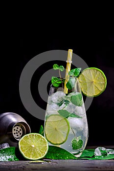 Refreshing summer mojito cocktail with ice cubes, fresh mint and lime