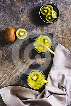 Refreshing tropical drink mojito with kiwi in glasses on the table top and vertical view