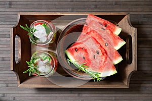 Refreshing watermelon cocktail with rosemary with ice and watermelon slices