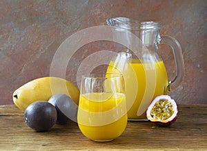 A refreshing yellow drink. The cocktail consists of mango juice, passion fruit, and citrus fruits: orange and lemon in a glass jug