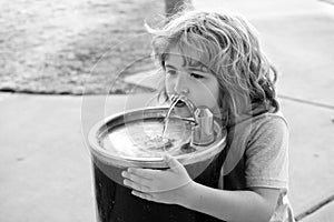 Refreshment solution. Thirsty kid drink water from drinking fountain. Thirst quenching