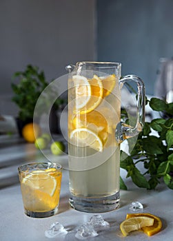 Refreshment Summer drink. Traditional lemonade with lemon and orange mint and ice on white.