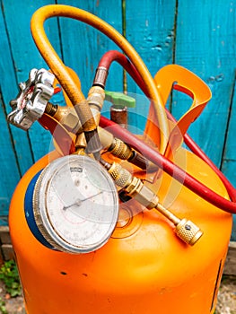 Refrigerant cylinder and hoses with pressure gauge