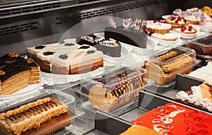 Refrigerated display case with delicious desserts in supermarket