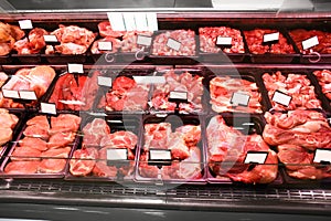 Refrigerated display case with fresh meat in supermarket