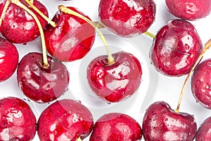 Refrigerated juicy cherries with iced water drops spread around