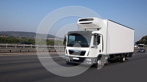 Refrigeration truck is driving on highway photo