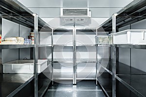 Refrigerator chamber with steel shelves in a restaurant photo