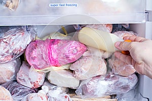 Refrigerator with frozen food meat, milk, vegetables.