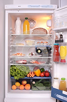 Refrigerator full with some kinds of food photo