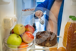 Refrigerator with nice tasteful chocolate cake is big ordeal for photo
