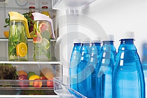 In refrigerators bottled water and lemonade from fresh fruit in decanters, storage of drinks in refrigerators