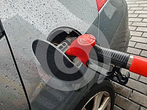 refueling Car fill with petrol gasoline at gas station and petrol pump filling fuel nozzle in fuel tank