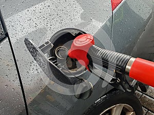 refueling Car fill with petrol gasoline at gas station and petrol pump filling fuel nozzle in fuel tank