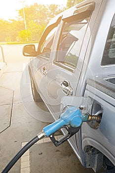 Refueling Car fills with petrol gasoline at a gas station and Petrol pump filling fuel nozzle in the fuel tank of the car