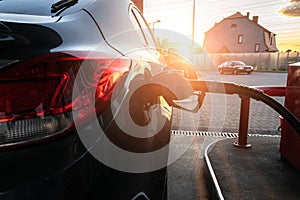 Refueling car. Pump gas at petrol fuel station. Gasoline oil nozzle tank from hand person. Automotive industry or