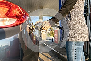 Refueling car. Pump gas at petrol fuel station. Gasoline oil nozzle tank from hand person. Automotive industry or transportation