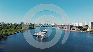 Refueling a riverboat on a river with a refueling barge. Refueling on water, fuel station on the river, river transport.