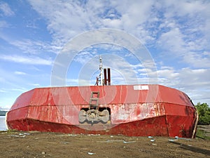 a refueling ship moored on the coast of Nunukan Island, with a view of the cloudy sky