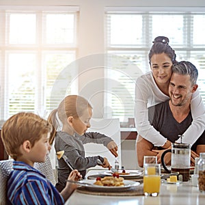 Refuelling their bodies for the day ahead. a family having breakfast together.