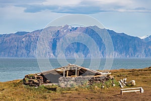 A refuge - harborage made by stones and wood on the coastline in Pond Inlet, Baffin Island, Canada