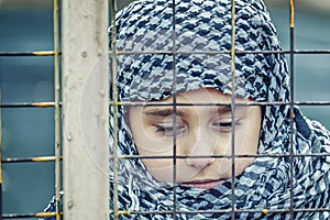 A refugee girl from the east in a headscarf