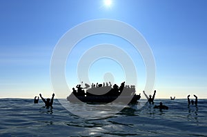 Refugees on a big rubber boat in the middle of the sea that require help