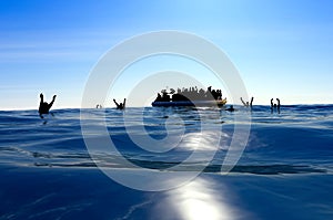 Refugees on a big rubber boat in the middle of the sea that require help