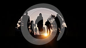 Refugees and immigrants looking for a new hope in life. Silhouette. Column of migrants passing through a tunnel