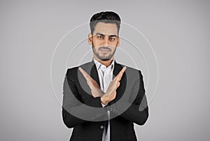 Refusal Concept. Young Arab Businessman Showing Stop Gesture With Crossed Arms