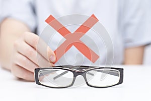 Refusal of glasses for sight. hands refuse glasses. cross on glasses. Vision improvement,