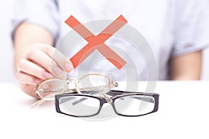 Refusal of glasses for sight. hands refuse glasses. cross on glasses. Vision improvement