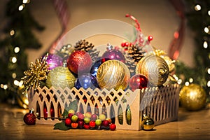 Basket with colorful Christmas balls and pine cones photo