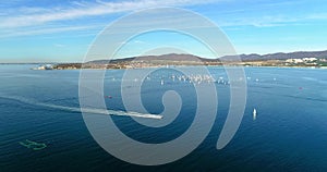 Regatta in Gelendzhik Bay. A lot of small one-and two-person yachts jostle in the Bay with a light wind. The view from