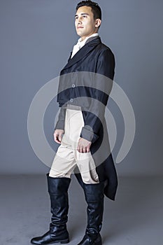 A Regency gentleman wearing a tailed jacket against a grey backdrop